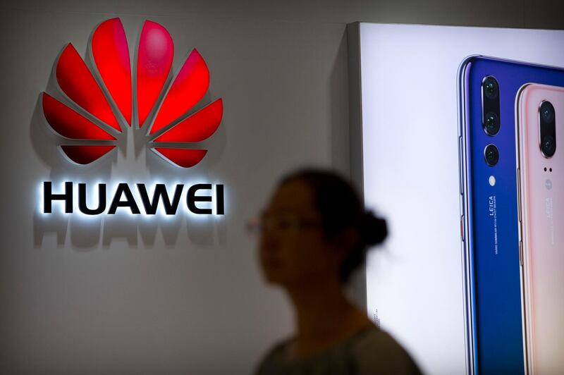 A shopper walks past a Huawei store at a shopping mall in Beijing Wednesday, July 4, 2018. China has produced success stories including Huawei Technologies Ltd., the biggest global seller of switching gear for phone companies and the No. 3 smartphone brand. The company has developed its own Kirin line of chip sets to power some of its phones, reducing reliance on U.S.-based Qualcomm Corp.â€™s Snapdragon and other foreign suppliers. (AP Photo/Mark Schiefelbein)