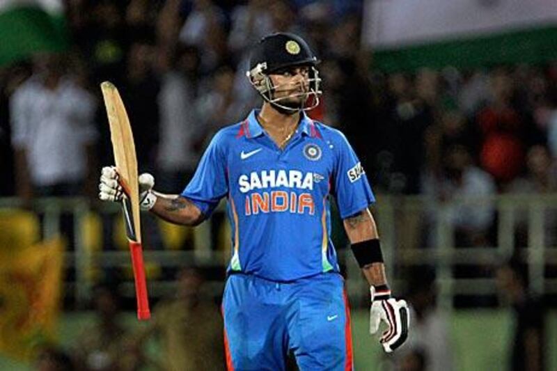 India’s Virat Kohli, whose century helped India to victory, raises his bat after passing the 50 mark yesterday.