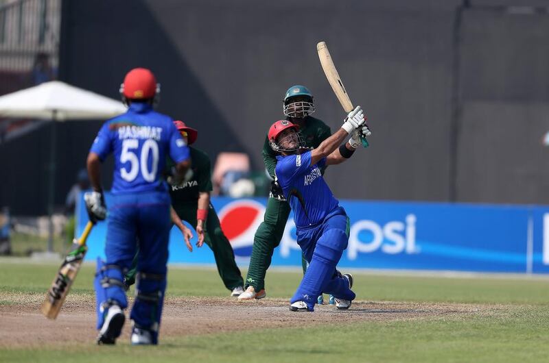 Mohammad Nabi plays a shot in Afghanistan's seven-wicket win over Kenya at Sharjah on Friday. The victory clinches a spot in the 2015 World Cup for the Afghans. Pawan Singh / The National