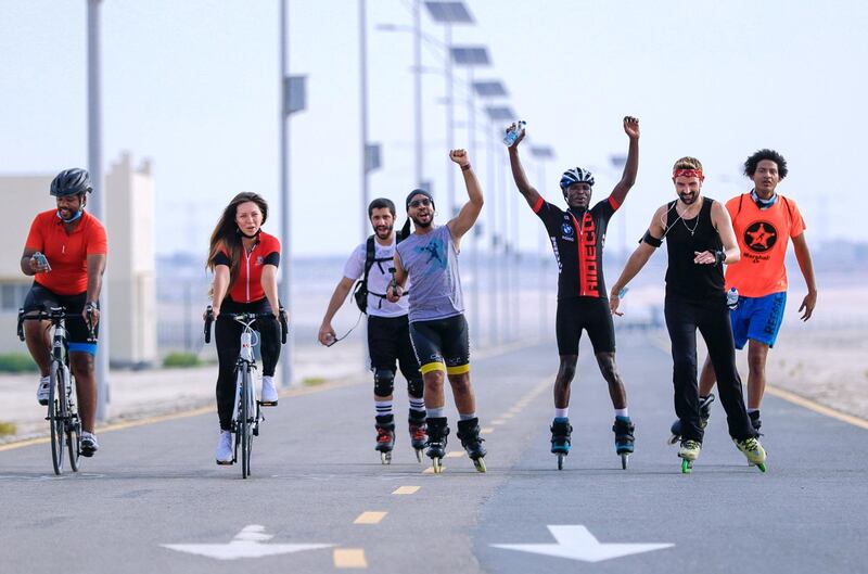 Abu Dhabi, United Arab Emirates, August 21, 2020.   The Madrollers skating group at the Al Wathba Bicycle Track do a  8 km. fun sprint.
  The skating group has members from Dubai and Abu Dhabi.  They encourage safety and discipline on roller-skates, skateboard, long-board and bicycles.  --  Veteran rollerbladers go back a few kilometers to cheer on Chief Benard (second from right), one of the novice skaters of the group who got left behind.  
Victor Besa /The National
Section:  Photo Project
Reporter: