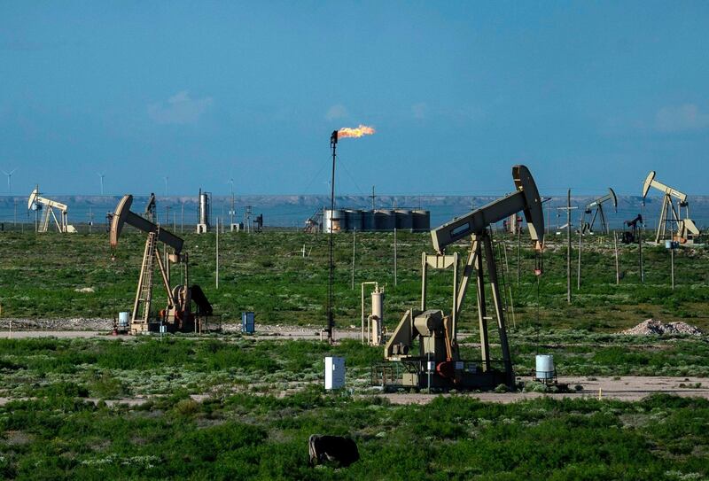 (FILES) In this file photo taken on April 23, 2020, pump jacks operate near Loco Hills in Eddy County, New Mexico. Permian Basin Crude oil extraction is one of the main economic drivers of this area.   US stock market regulators have begun an investigation of energy giant Exxon over the valuation for its assets in the large oil-producing Permian Basin region, The Wall Street Journal reported on January 15, 2021. The Journal report, citing unnamed sources, said the Securities & Exchange Commission probe focused on unrealistic assumptions for highest-producing US oil field. / AFP / Paul Ratje
