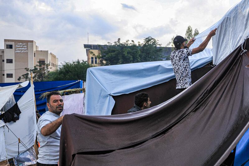 A tent pitched in Khan Younis in the southern Gaza Strip is covered with insulating plastic by Palestinians taking shelter amid Israeli bombardment around Nasser Hospital. AFP