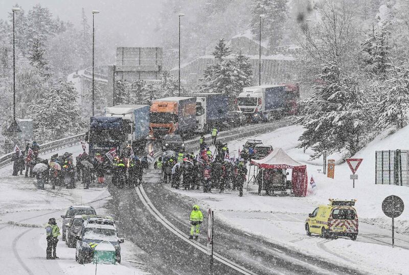 Ski resort workers block the road to the Frejus tunnel crossing the border with Italy in France to protest against the French government's decision to close the resorts for the 2020/2021 winter season. AFP