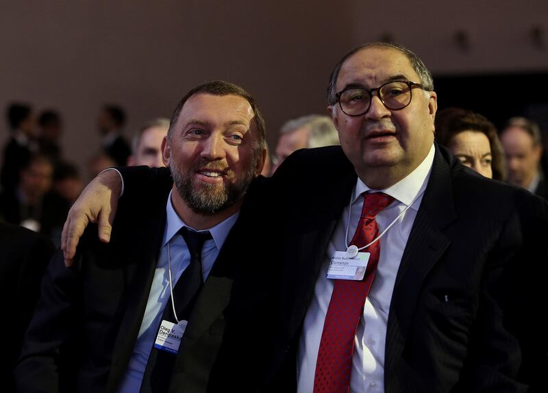 FILE: Oleg Deripaska, chief executive officer of United Co. Rusal, left, smiles with Russian billionaire Alisher Usmanov, before the opening keynote speech on the first day of the World Economic Forum (WEF) in Davos, Switzerland, on Wednesday, Jan. 23, 2013. United Co. Rusal -- the biggest aluminum maker outside China -- and seven other Deripaska-linked firms were the most prominent targets in a list of 12 Russian companies the U.S. hit with sanctions on Friday intended to punish the country for actions in Crimea, Ukraine and Syria, and attempting to subvert Western democracies. Our editors select the best archive images on Deripaska and Rusal. Photographer: Chris Ratcliffe/Bloomberg