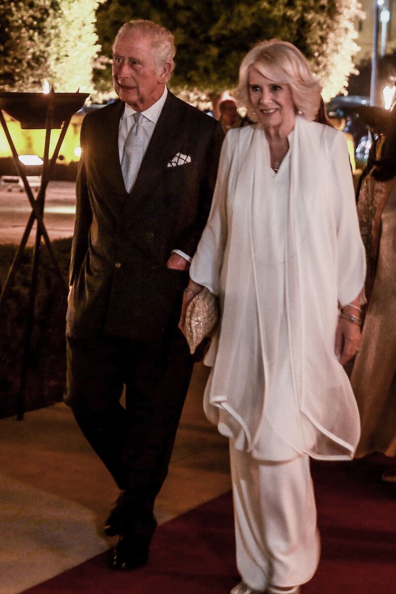 Prince Charles and Camilla, Duchess of Cornwall, wearing a white Anna Valentine tunic and trousers, arrive for a centenary celebration of the founding of the Jordanian state, at the Jordan Museum in Amman. AFP