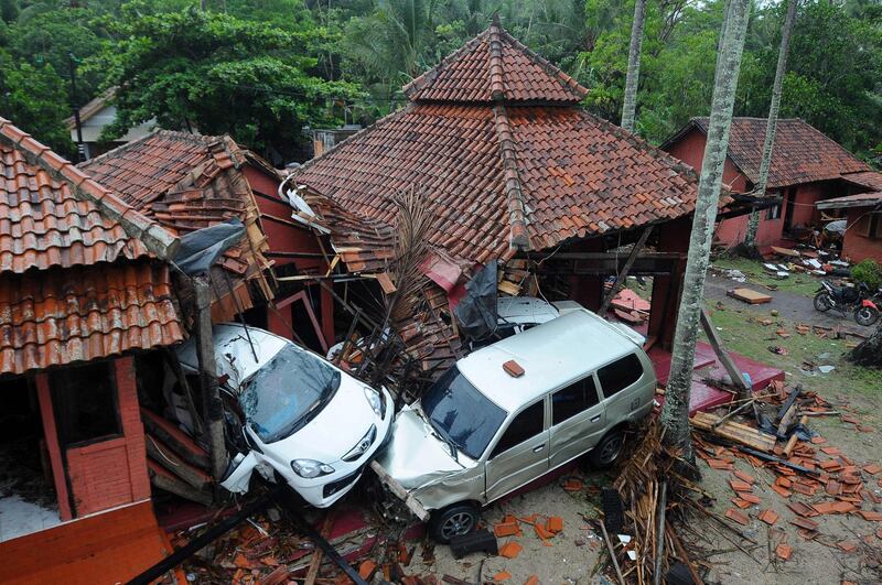 Damaged buildings and cars are seen in Anyer, Serang. AFP