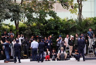 Members of the media work as security personnel keep watch near the entrance to the Capella Hotel in Singapore June 12, 2018.  REUTERS/Kim Kyung-hoon