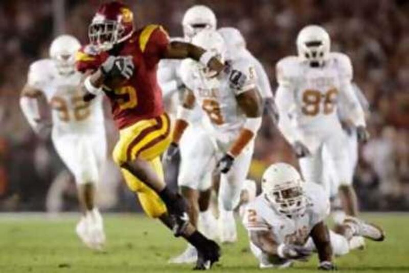 The NCAA ripped USC for a lack of institutional control, condemning the star treatment afforded to Reggie Bush, seen here with the ball, and OJ Mayo.