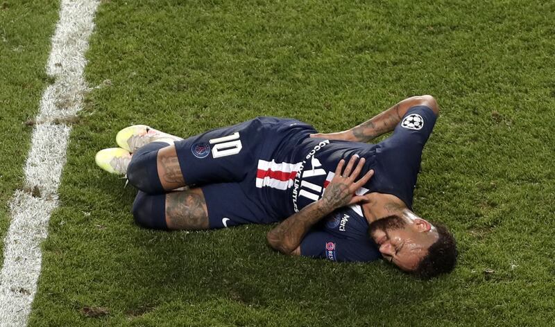 Neymar rolls on the floor after a heavy challenge.  EPA