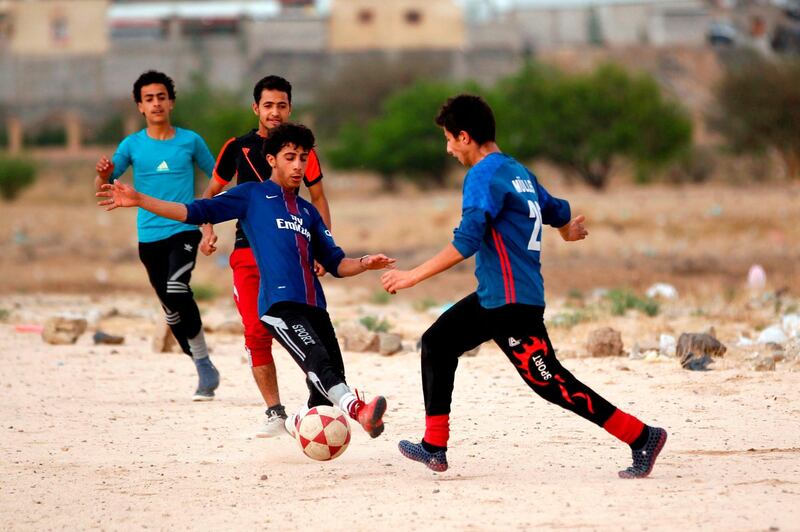 Yemeni youth take part in a football match in their neighbourhood in the capital Sanaa. Mohammed Huwais / AFP