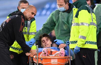 epa08694698 Adrian Bernabe of Manchester City is stretchered off injured watch by Manchester City manager Pep Guardiola (L) during the English Carabao Cup third round match between Manchester City and AFC Bournemouth in Manchester, Britain, 24 September 2020.  EPA/Laurence Griffiths / POOL EDITORIAL USE ONLY. No use with unauthorized audio, video, data, fixture lists, club/league logos or 'live' services. Online in-match use limited to 120 images, no video emulation. No use in betting, games or single club/league/player publications.