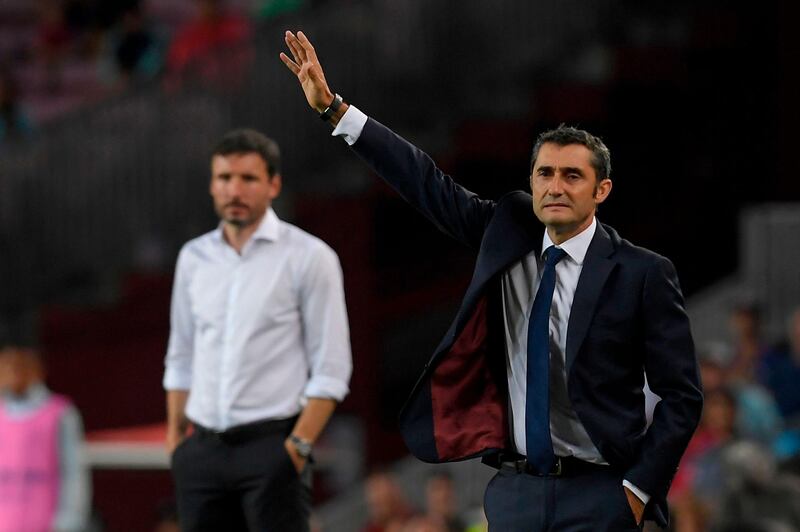 Barcelona's coach Ernesto Valverde gestures next to PSV Eindhoven's coach Mark van Bommel. AFP