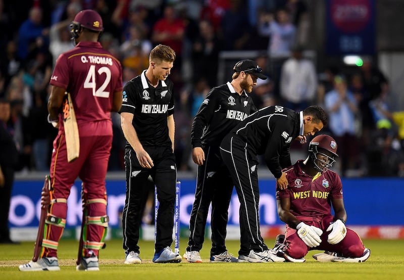 MANCHESTER, ENGLAND - JUNE 22:  Carlos Brathwaite of West Indies is consoled as he is caught on the boundary and West Indies lose the match during the Group Stage match of the ICC Cricket World Cup 2019 between West Indies and New Zealand at Old Trafford on June 22, 2019 in Manchester, England. (Photo by Clive Mason/Getty Images)