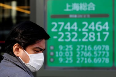 A man stands in front of a screen showing the Shanghai Composite index outside a brokerage in Tokyo, Japan. China's central bank injected 1.2 trillion yuan of liquidity into the markets via reverse repo operations on Monday. Reuters