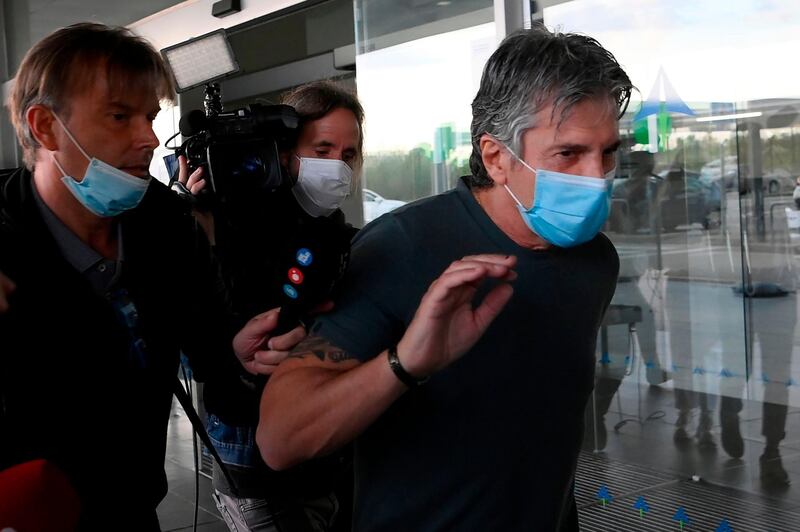 Jorge Messi is chased by TV camera crews at Barcelona airport. AFP