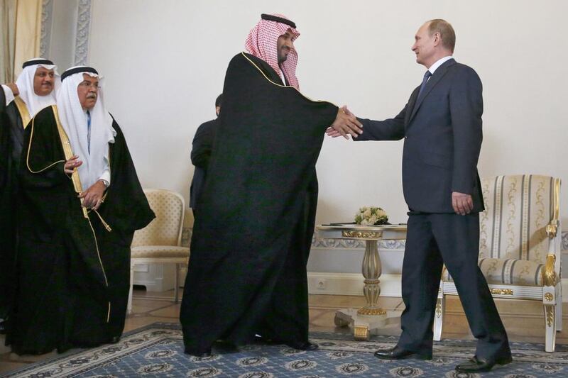 Russian president Vladimir Putin shakes hands with Saudi Arabia's defence minister Prince Mohammed bin Salman in St Petersburg, Russia. Grigory Dukor / Pool Photo via AP