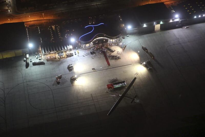 'Solar Impulse 2' is pictured from above next to a huge Emirati flag, at Al Bateen Executive Airport, after completing its record-breaking trip early on July 26, 2016.