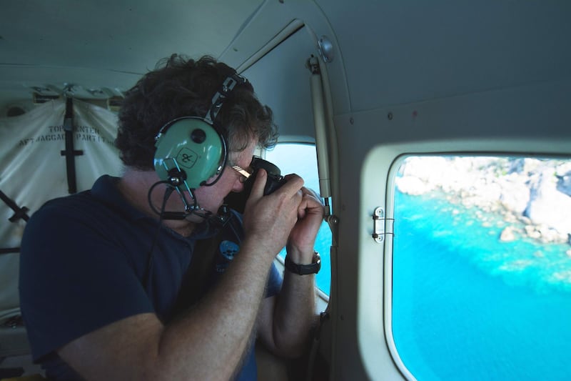 This undated handout photo received on April 6, 2020 from the ARC Centre of Excellence for Coral Reef Studies at James Cook University, shows professor Terry Hughes conducting an   aerial survey of coral bleaching on the Great Barrier Reef. Australia's Great Barrier Reef has suffered its most widespread coral bleaching on record, scientists said on April 7, 2020 in a dire warning about the threat posed by climate change to the world's largest living organism. James Cook University professor Terry Hughes said a comprehensive survey last month found record sea temperatures had caused the third mass bleaching of the 2,300-kilometre (1,400-mile) reef system in just five years.
 - TO BE USED EXCLUSIVELY FOR AFP STORY AUSTRALIA-ENVIRONMENT-CLIMATE-REEF
RESTRICTED TO EDITORIAL USE - MANDATORY CREDIT "AFP PHOTO / JAMES COOK UNIVERSITY" - NO MARKETING NO ADVERTISING CAMPAIGNS - DISTRIBUTED AS A SERVICE TO CLIENTS - NO ARCHIVE

 / AFP / JAMES COOK UNIVERSITY AUSTRALIA / Handout / TO BE USED EXCLUSIVELY FOR AFP STORY AUSTRALIA-ENVIRONMENT-CLIMATE-REEF
RESTRICTED TO EDITORIAL USE - MANDATORY CREDIT "AFP PHOTO / JAMES COOK UNIVERSITY" - NO MARKETING NO ADVERTISING CAMPAIGNS - DISTRIBUTED AS A SERVICE TO CLIENTS - NO ARCHIVE

