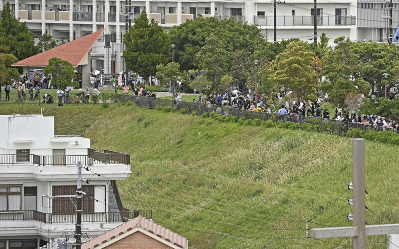 People head for higher ground after a tsunami warning in Naha, Okinawa prefecture, Japan. AP