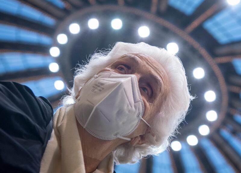 After receiving her vaccination against the novel coronavirus, 90-year-old Odores H. sits under the domed roof of the vaccination centre in the Festhalle in Frankfurt.  AP
