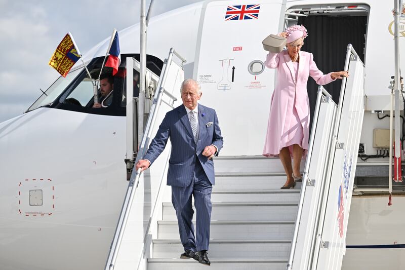 The king and queen arrive at Orly Airport. PA