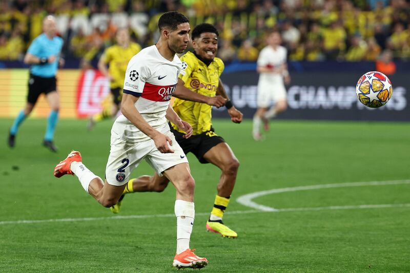 PSG full-back Achraf Hakimi vies for the ball with Dortmund defender Ian Maatsen. AFP