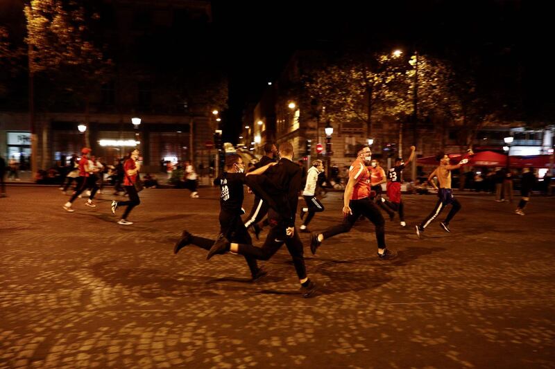 Paris Saint-Germain supporters running on the Champs-Elysees. AFP