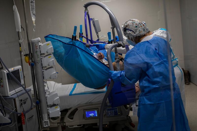 A medical team transports a COVID-19 patient at the intensive care unit at the Nurse Isabel Zendal Hospital in Madrid, Spain, Tuesday, March 9, 2021. (AP Photo/Bernat Armangue)