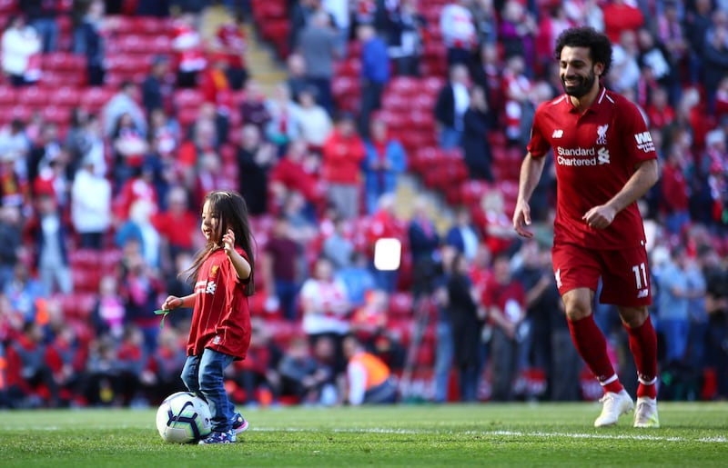 Makka, age 5, kicks the ball with her father. AP Photo