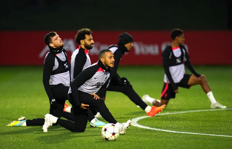 Liverpool's Thiago Alcantara and Mohamed Salah stretch during a training. PA