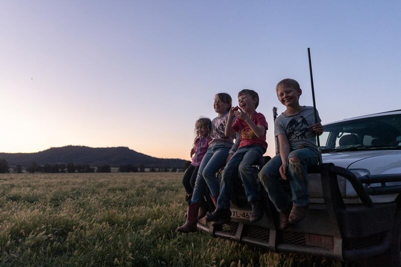Bonnie, Charlie, Harry and Heidi Taylor play around on the family farm at dusk in Coonabarabran, Australia. Getty Images