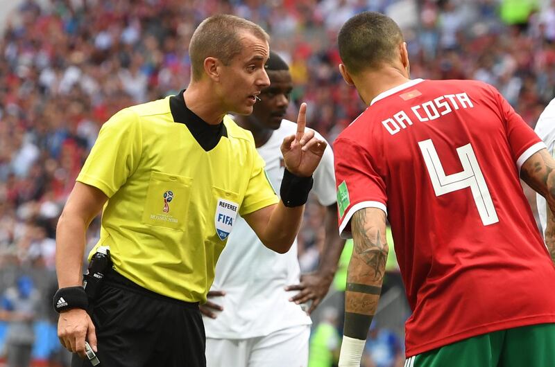 US referee Mark Geiger, left, speaks to Manuel da Costa of Morocco. Facundo Arrizabalaga / EPA