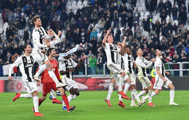 Juventus players celebrate in front of fans after beating SPAL. EPA