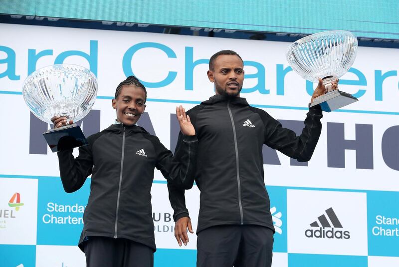 DUBAI, UNITED ARAB EMIRATES , Jan 24  – 2020 :- Olika Adugna Bikila from Ethiopia (right) and Worknesh Degefa Debele from Ethiopia (left) with their trophies after winning the men and women Standard Chartered Dubai Marathon 2020 held on the Umm Suqeim Road in Dubai. ( Pawan  Singh / The National ) For News/Online/Instagram.