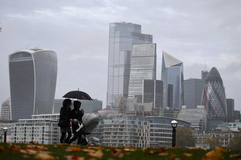 (FILES) In this file photo taken on November 01, 2020 People walk along the southern bank of the River Thames with the office towers of the City of London in the background in London on November 1, 2020 as England prepares to enter into a second coronavirus lockdown in an effort to stem soaring infections.  Bank of England governor Andrew Bailey on March 15, 2021 forecast that UK economic activity would return to its pre-coronavirus level at the end of 2021 following the country's vaccine rollout. The earlier-than-expected recovery -- the BoE's expectation had been for early 2022 -- comes ahead of the central bank's latest interest decision on March 18.
 / AFP / JUSTIN TALLIS
