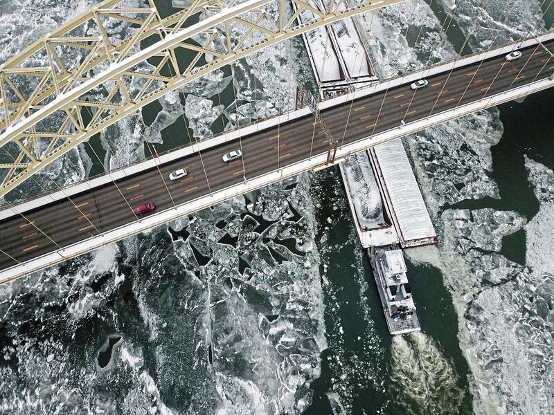 A barge cuts through ice on the Ohio River in Pittsburgh. Haley Nelson / Pittsburgh Post-Gazette via AP