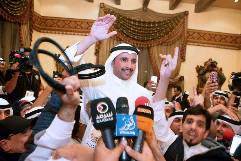 Kuwaiti candidate and former parliament speaker Marzouq Al Ghanem (C) celebrates with his supporters in Kuwait City following the announcment of his victory in the parliamentary election early on November 27, 2016. Yasser Al Zayyat/AFP


