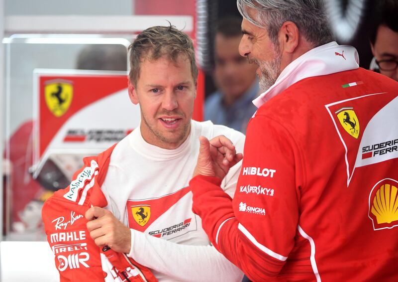 Ferrari's German driver Sebastian Vettel speaks with team principal of the Ferrari Formula One team Maurizio Arrivabene (R) during the second practice session at the Spa-Francorchamps circuit in Spa on August 25, 2017 ahead of the Belgian Formula One Grand Prix. / AFP PHOTO / Emmanuel DUNAND