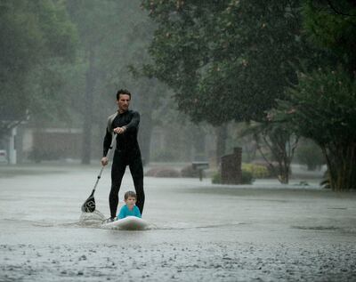 Alexendre Jorge evacuates Ethan Colman, 4, from a neighborhood inundated by floodwaters from Tropical Storm Harvey on Monday, Aug. 28, 2017, in Houston, Texas. (AP Photo/Charlie Riedel)