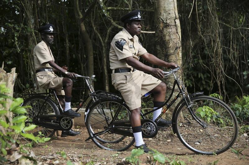 Actors Sadiq Daba, left, and Aderupoko, ride bicycles as they perform during filming for ‘October 1, a police thriller directed by Kunle Afolayan, in Ilaramokin village, Nigeria.