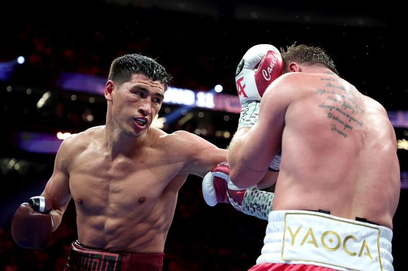 Dmitry Bivol punches Canelo Alvarez during their WBA light heavyweight title fight at T-Mobile Arena.
