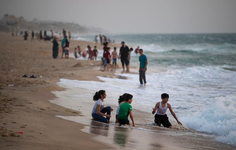 Palestinian families wait to have their Iftar breaking a Ramadan fasting day on the beach of Gaza City. AP Photo