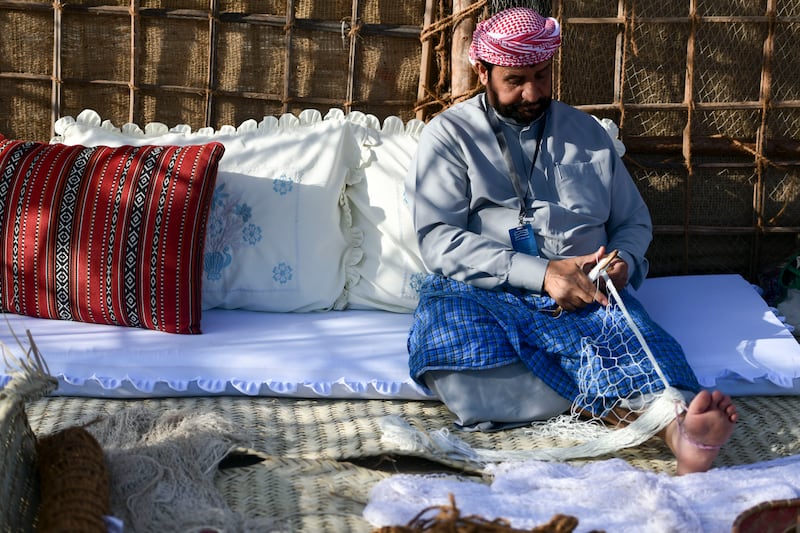 An Emirati makes traditional fishing nets 