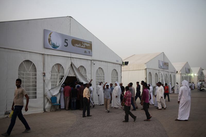 Abu Dhabi, UAE, June 18, 2015:

Thousands gathered at the Grand Mosque to receive their complimentary Iftar on the first night of Ramadan. 

Men walk inside of the Iftar tents.  
Lee Hoagland/The National. *** Local Caption ***  LH18_07_MOSQUE_IFTAR0005.JPG