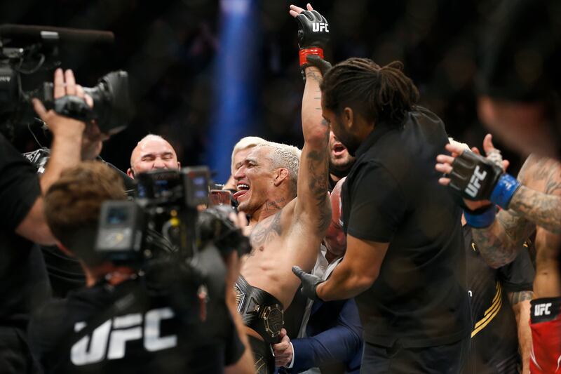 Charles Oliveira celebrates after defeating Dustin Poirier. AP Photo
