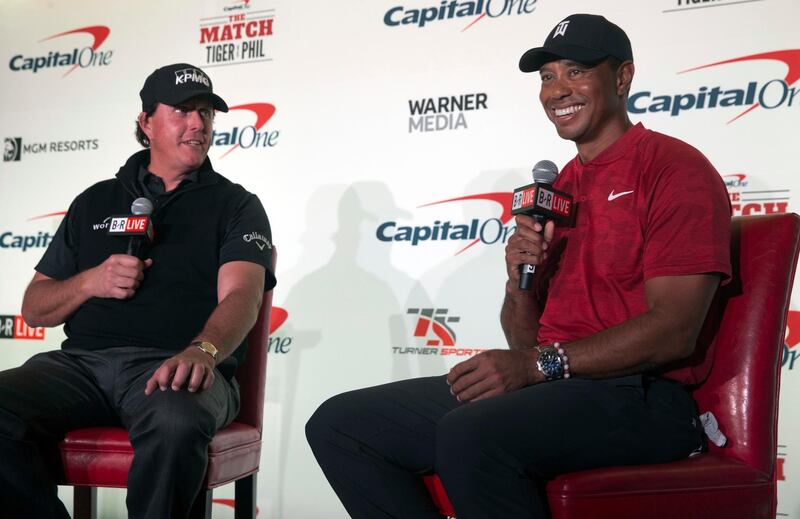 Phil Mickelson, left, and Tiger Woods speak during a news conference  at Shadow Creek Golf Course in North Las Vegas Tuesday, Nov. 20, 2018. The golfers will face off in a match play event on Friday. (Steve Marcus/Las Vegas Sun via AP)