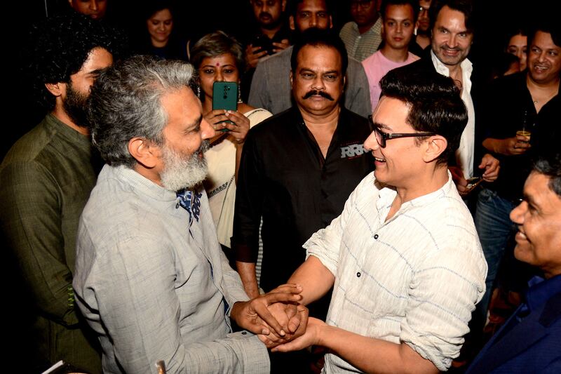 Bollywood actor Aamir Khan, right, attends an event to celebrate the box-office success of RRR in April 2022. AFP