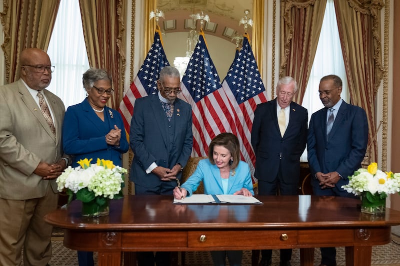 House Speaker Nancy Pelosi signs HR 55, the 'Emmett Till Antilynching Act', which designates lynching as a hate crime under federal law, during a ceremony on Capitol Hill in Washington, with Democratic Representatives Bennie Thompson, Joyce Beatty, Bobby Rush, House Majority Leader Steny Hoyer and radio host Joe Madison. AP