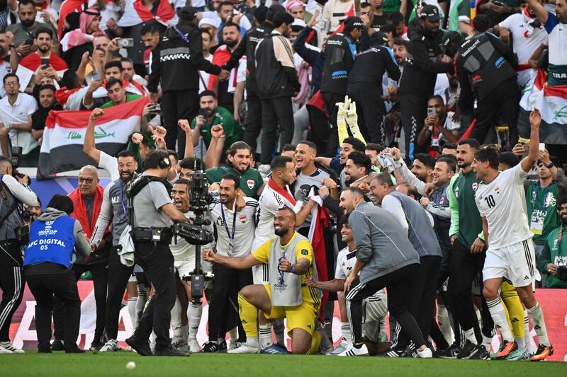 Iraq players and coaching staff celebrate after the match. AFP