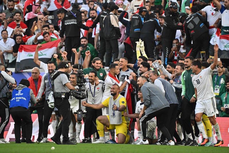 Iraq players and coaching staff celebrate after the match. AFP